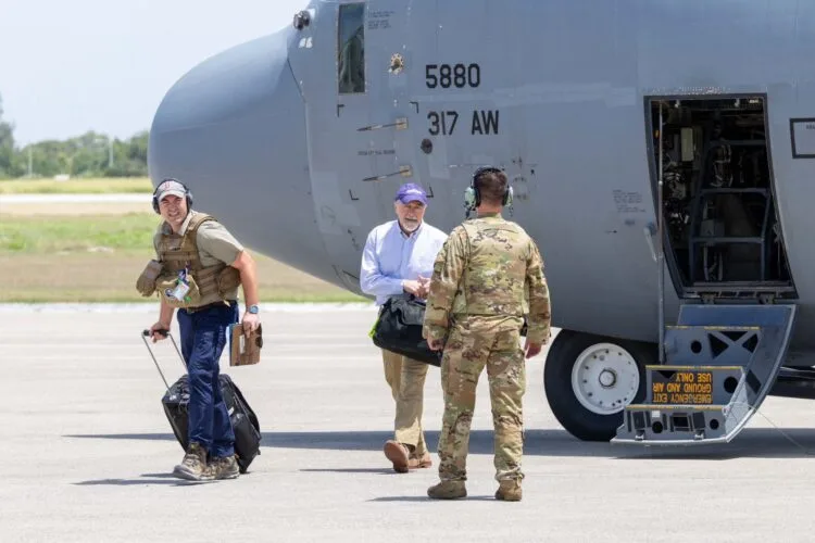 U.S. Ambassador Henry T. Wooster arrives in Haiti wearing military style trousers symbolizing a strong security focused diplomatic mission